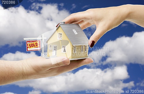 Image of Reaching For A Home with Sold Real Estate Sign