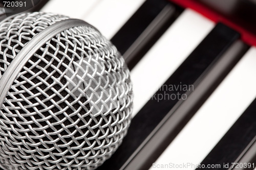 Image of Microphone Laying on Electronic Keyboard