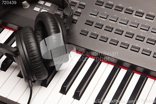 Image of Headphones Laying on Electronic Keyboard