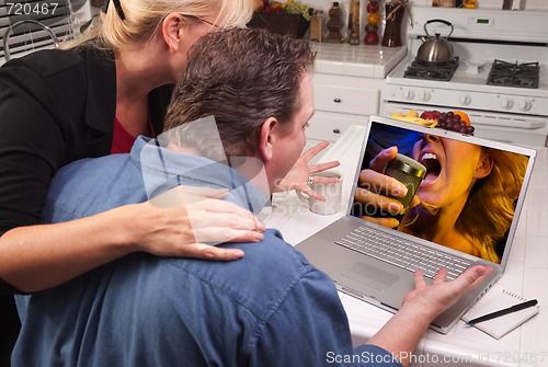 Image of Couple In Kitchen Using Laptop - Music Entertainment