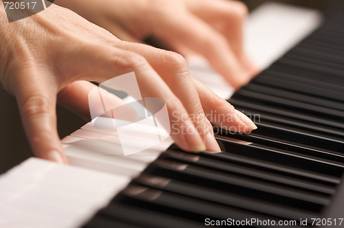 Image of Woman's Fingers on Digital Piano Keys