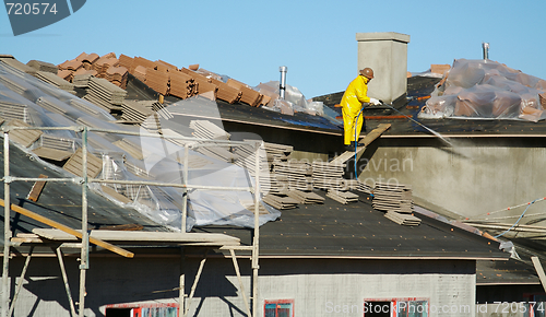 Image of Construction Worker Pressure Washes 