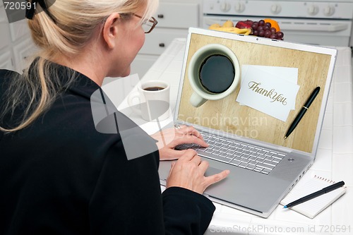 Image of Woman In Kitchen Using Laptop - E-commerce