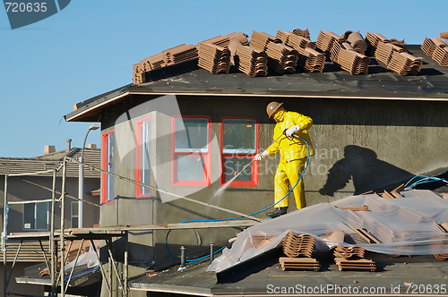 Image of Construction Worker Pressure Washes 