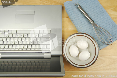 Image of Laptop, eggs and mixer 