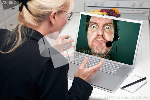 Image of Excited Woman In Kitchen Using Laptop Ð Poor Custmer Support