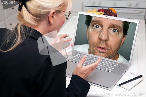 Image of Excited Woman In Kitchen Using Laptop - Intrusion of Privacy