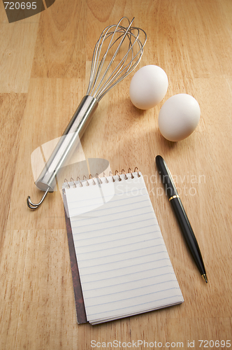 Image of Mixer, Eggs, Pen and Pad of Paper