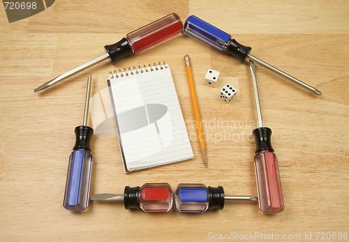 Image of House Shaped by Screwdrivers and Pad of Paper with Dice