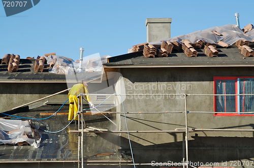 Image of Construction Worker Pressure Washes 