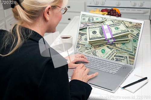 Image of Woman In Kitchen Using Laptop - Money
