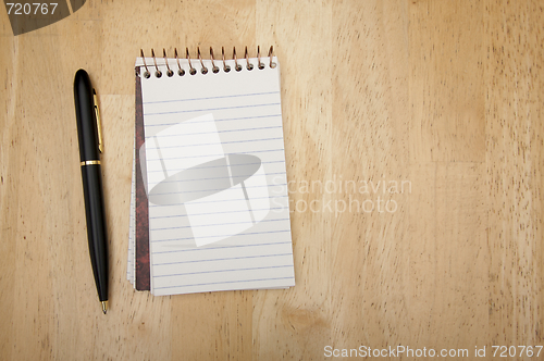 Image of Note Pad and Pen on Wood