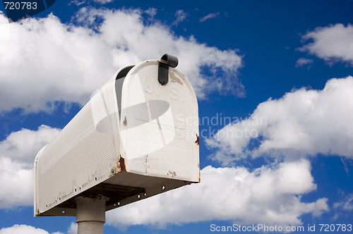 Image of Weathered Old Mailbox Against Blue Sky and Clouds