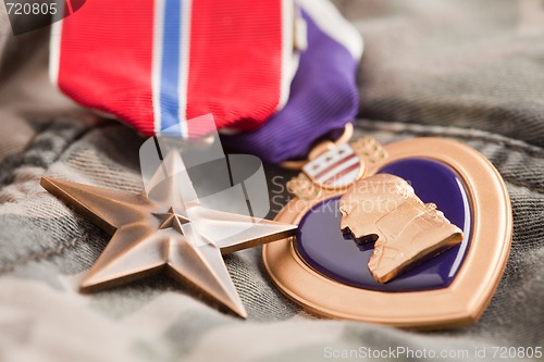 Image of Bronze and Purple Heart Medals on Camouflage Material