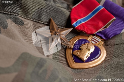 Image of Bronze and Purple Heart Medals on Camouflage Material