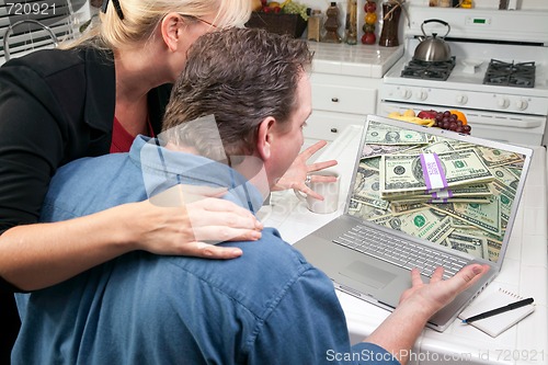 Image of Couple In Kitchen Using Laptop - Money