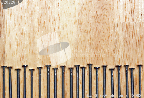 Image of Macro of Nails on Wood