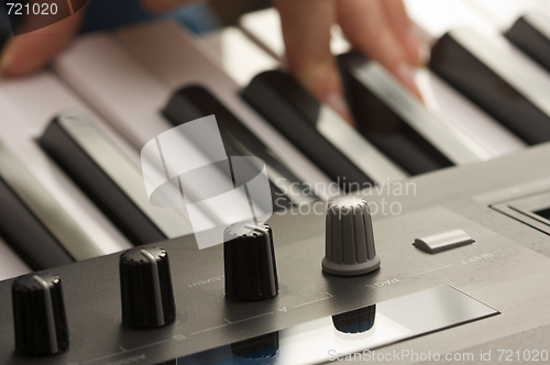 Image of Woman's Fingers on Digital Piano Keys