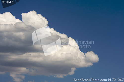 Image of Puffy Clouds on a blue sky.