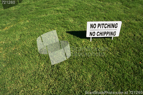 Image of No Pitching or Chipping Sign on Lush Green Grass