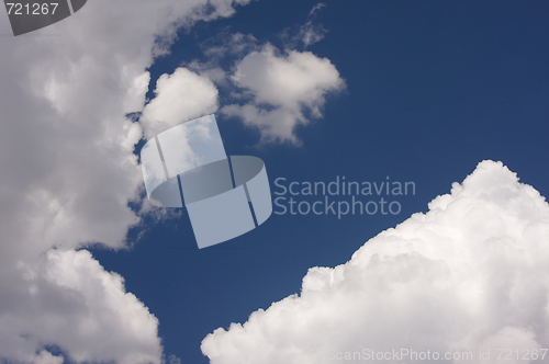 Image of Puffy Clouds on a blue sky.