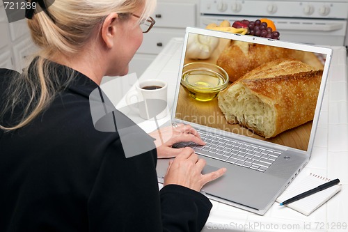 Image of Woman In Kitchen Using Laptop - Food and Recipes