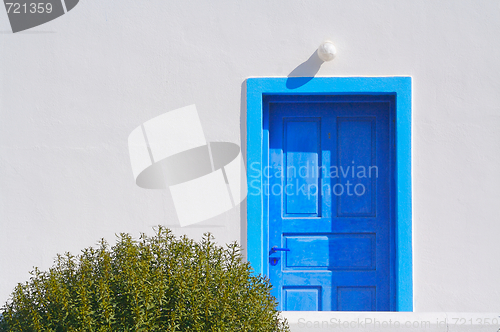 Image of Abstract close-up of Santorini home wall, door and lamp.