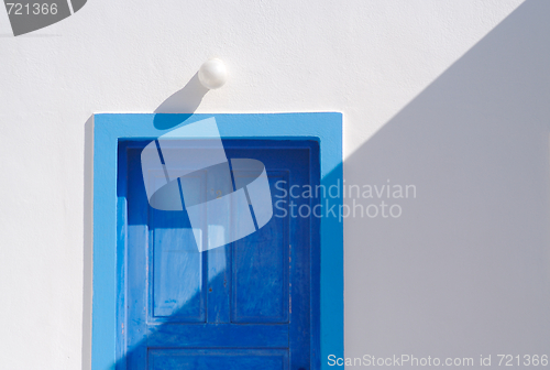 Image of Abstract close-up of Santorini home wall, door and lamp.