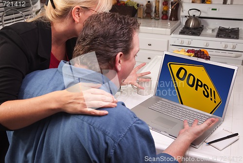 Image of Couple In Kitchen Using Laptop - Oops! Sign