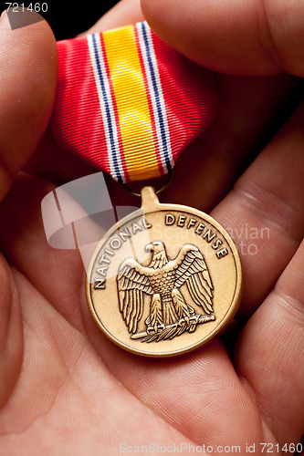Image of Man Holding National Defense War Medal