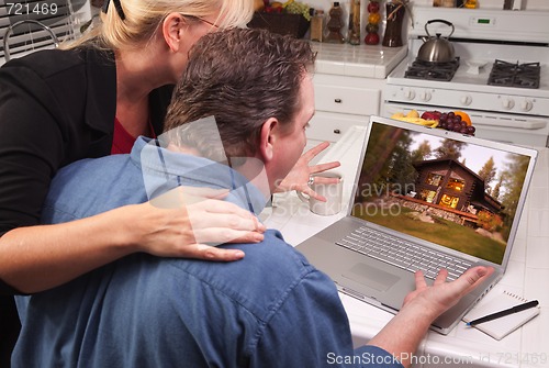 Image of Couple In Kitchen Using Laptop - Cabin