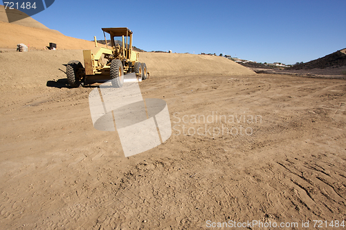 Image of Tractor at a Construction Site and dirt lot.