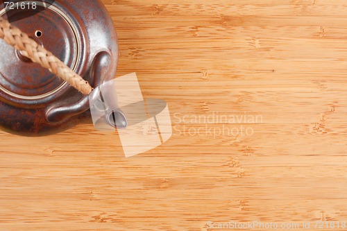 Image of Tea Pot and Bamboo Textured Surface