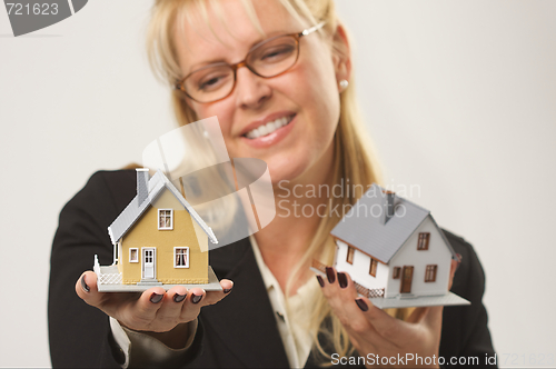 Image of Woman Holding Two Houses