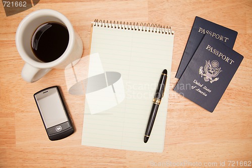 Image of Overhead Pad, Pen, Passports, Coffee and Cell Phone
