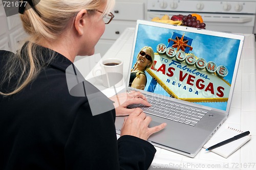 Image of Woman In Kitchen Using Laptop - Las Vegas