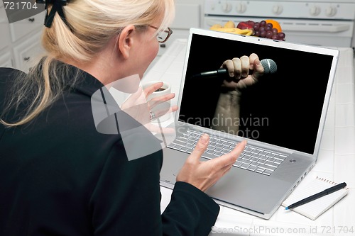 Image of Excited Woman In Kitchen Using Laptop - Freedom of Speech