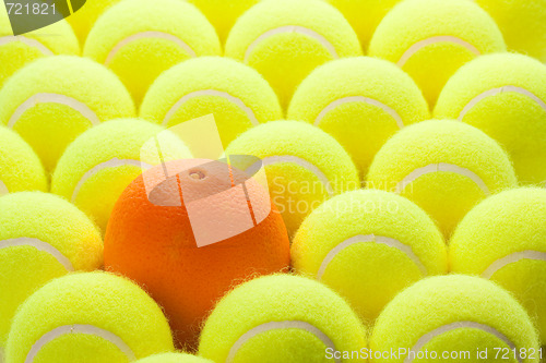 Image of Group of Tennis Balls and One Orange