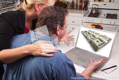 Image of Couple In Kitchen Using Laptop - Money