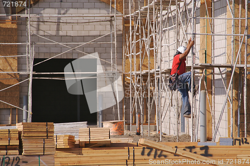 Image of Carpenter Climbing Down Scaffolding