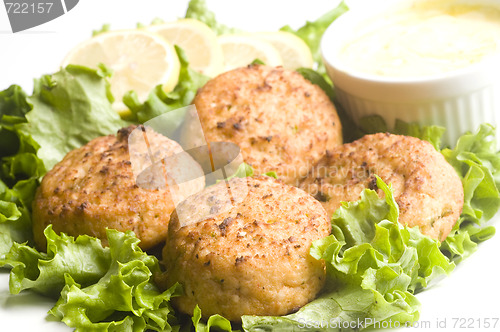 Image of lobster cakes with lemon wedges tartar sauce