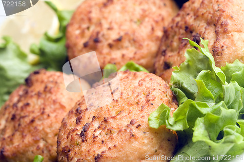 Image of lobster cakes with lemon wedges tartar sauce