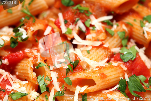 Image of Penne rigate pasta with tomato sauce. background