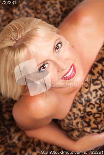 Image of Beautiful Blonde Woman Poses on Leopard Blanket.