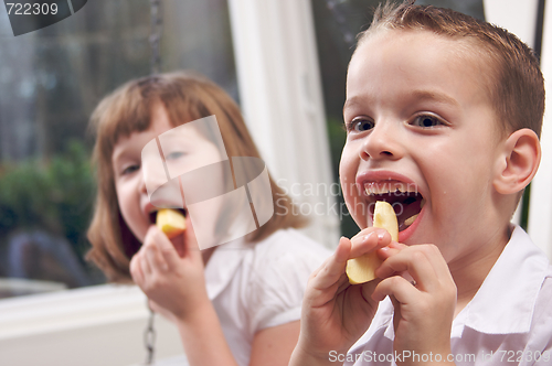 Image of Sister and Brother Eating an Apple