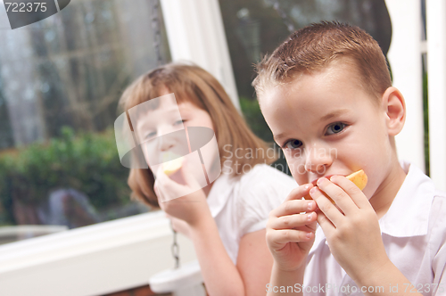Image of Sister and Brother Eating an Apple