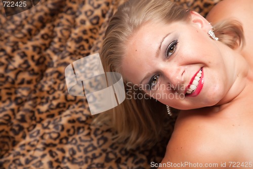 Image of Beautiful Blonde Woman Poses on Leopard Blanket.