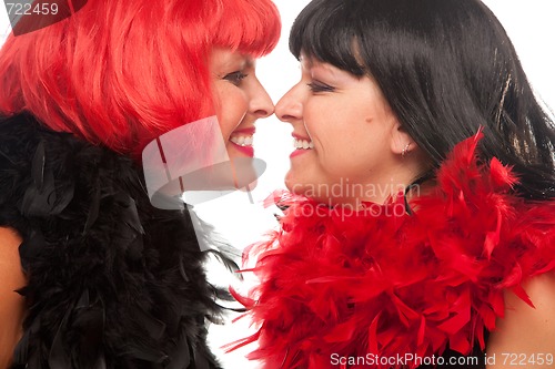 Image of Red and Black Haired Women Smiling at Each Other
