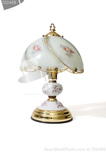 Image of Table lamp under the glass lampshade with flower pattern isolated