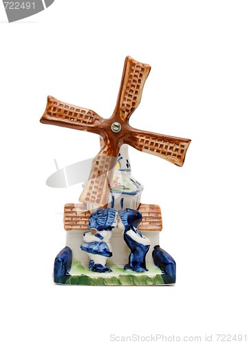 Image of Porcelain windmill souvenir with two kissing peasants isolated 